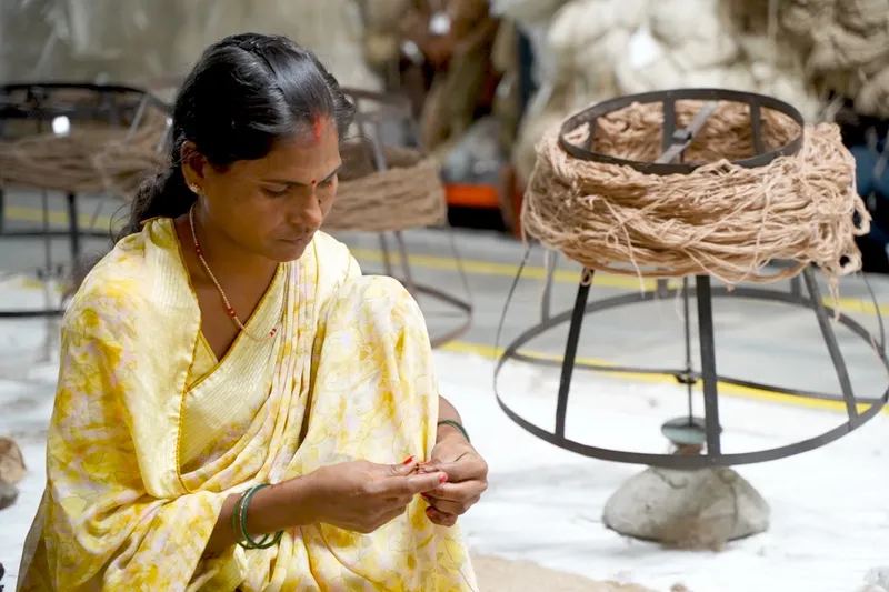 Ayesha Ansari hand-spinning yarn for a Kapetto rug