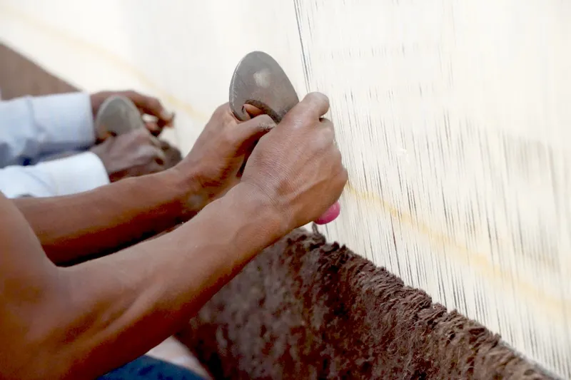 Mohan Lal sorting hand-dyed yarn skeins by color consistency